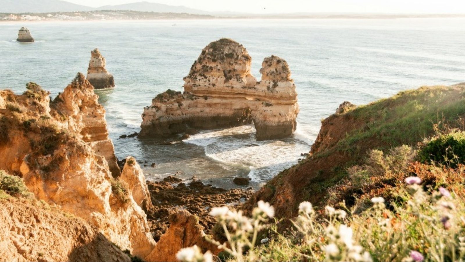 Rock stacks and sandstone cliffs above the blue Atlantic sea on the Algarve coast in Portugal